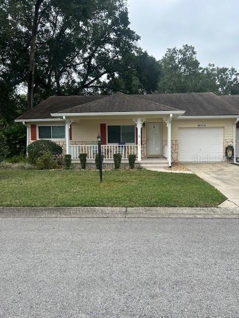 front view of a house with a yard and potted plants