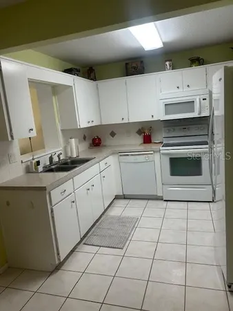 a kitchen with cabinets and appliances