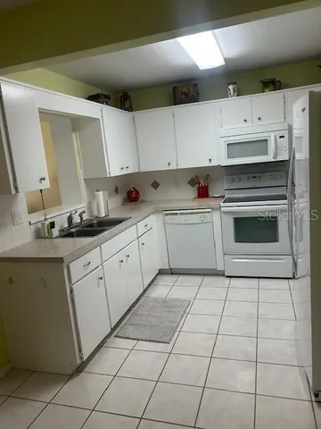 a kitchen with cabinets and appliances