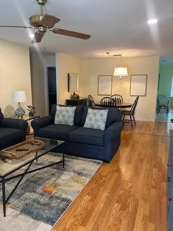 a living room with furniture and a chandelier