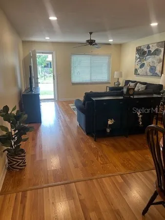 a living room with hard wood flooring and furniture
