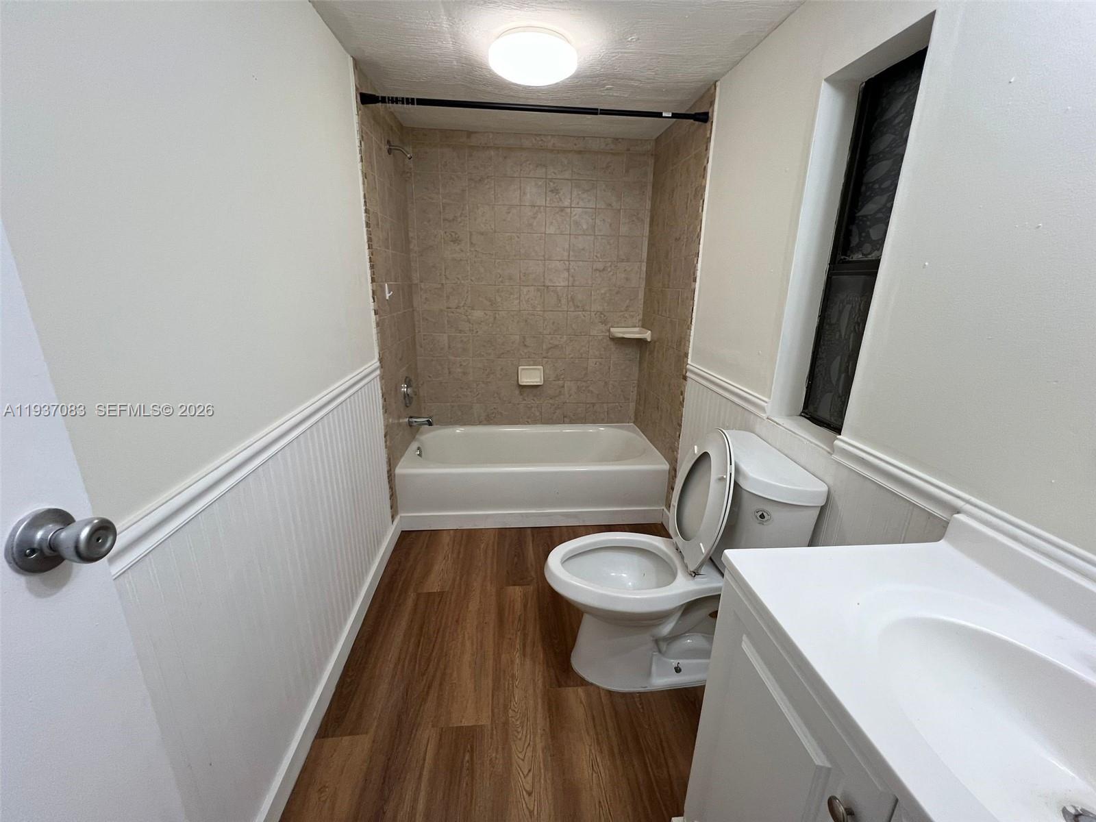 10492 South 228th Lane, Unit A Boca Raton, FL 33428 - Photo 15 of 37 a bathroom with a sink a toilet a mirror and shower