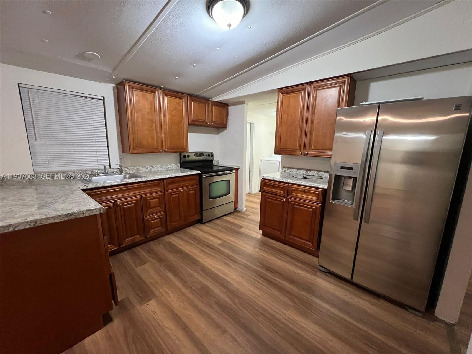 10492 South 228th Lane, Unit A Boca Raton, FL 33428 - Photo 16 of 37 a kitchen with stainless steel appliances granite countertop a stove a sink dishwasher a refrigerator and a oven