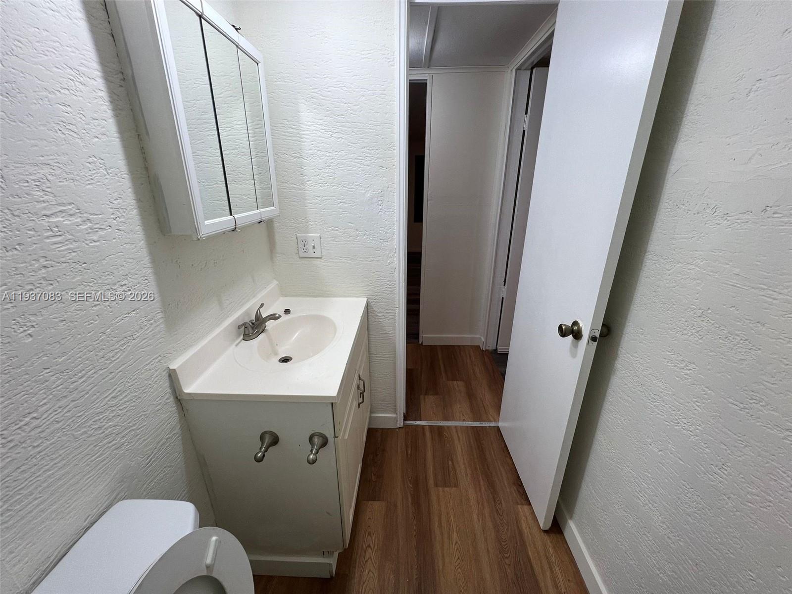 10492 South 228th Lane, Unit A Boca Raton, FL 33428 - Photo 31 of 37 a bathroom with sink and mirror with toilet