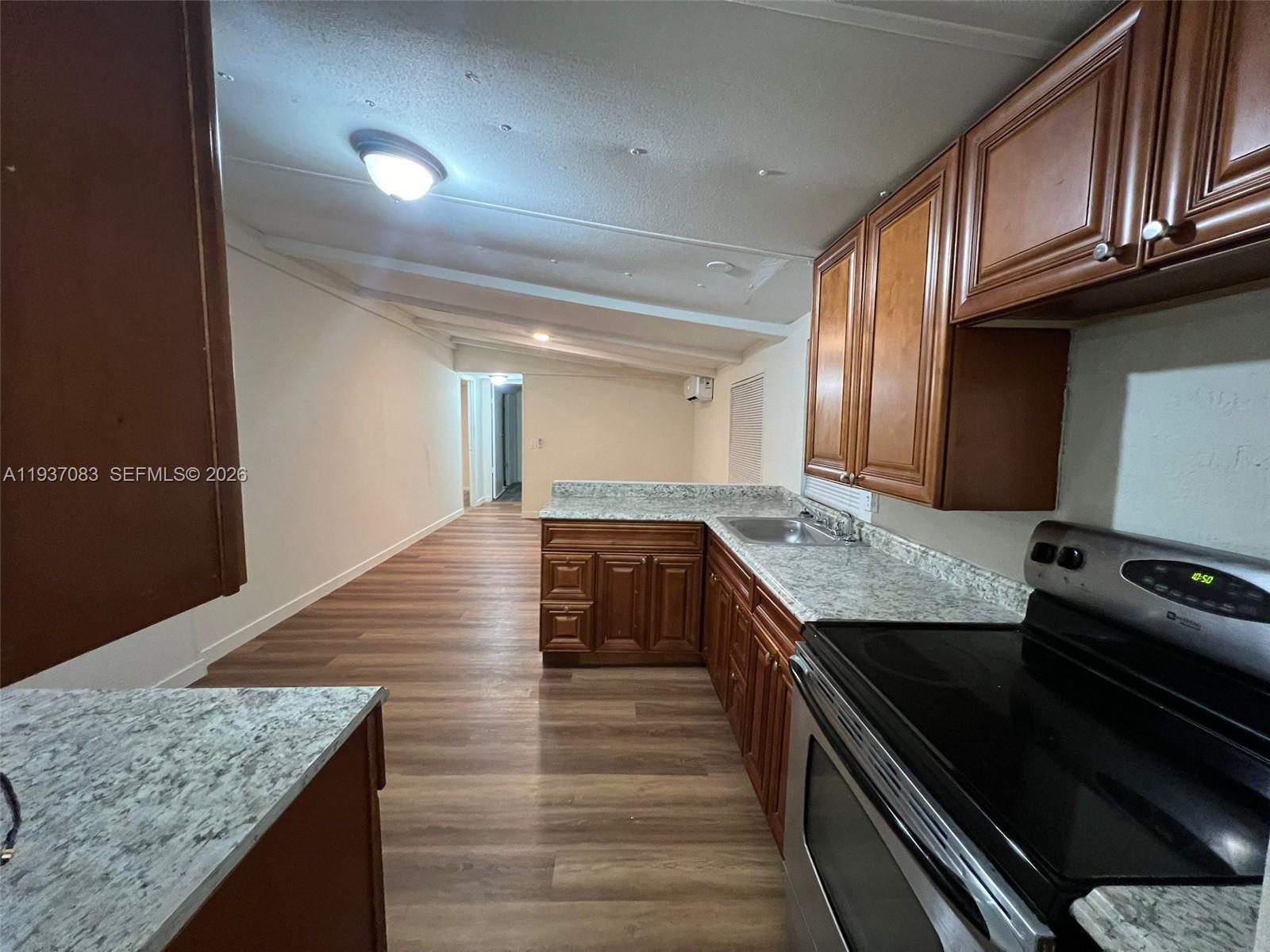 10492 South 228th Lane, Unit A Boca Raton, FL 33428 - Photo 33 of 37 a kitchen with granite countertop counter space a stove and cabinets