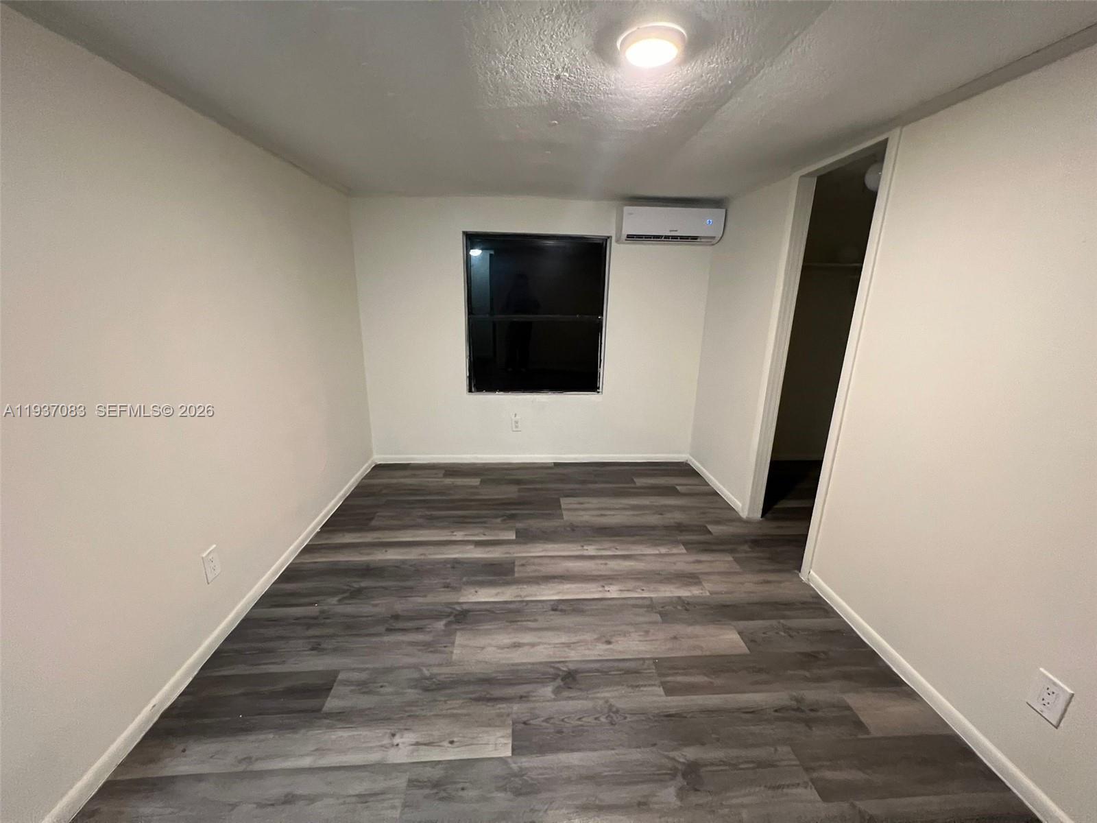 10492 South 228th Lane, Unit A Boca Raton, FL 33428 - Photo 36 of 37 a view of an empty room with wooden floor