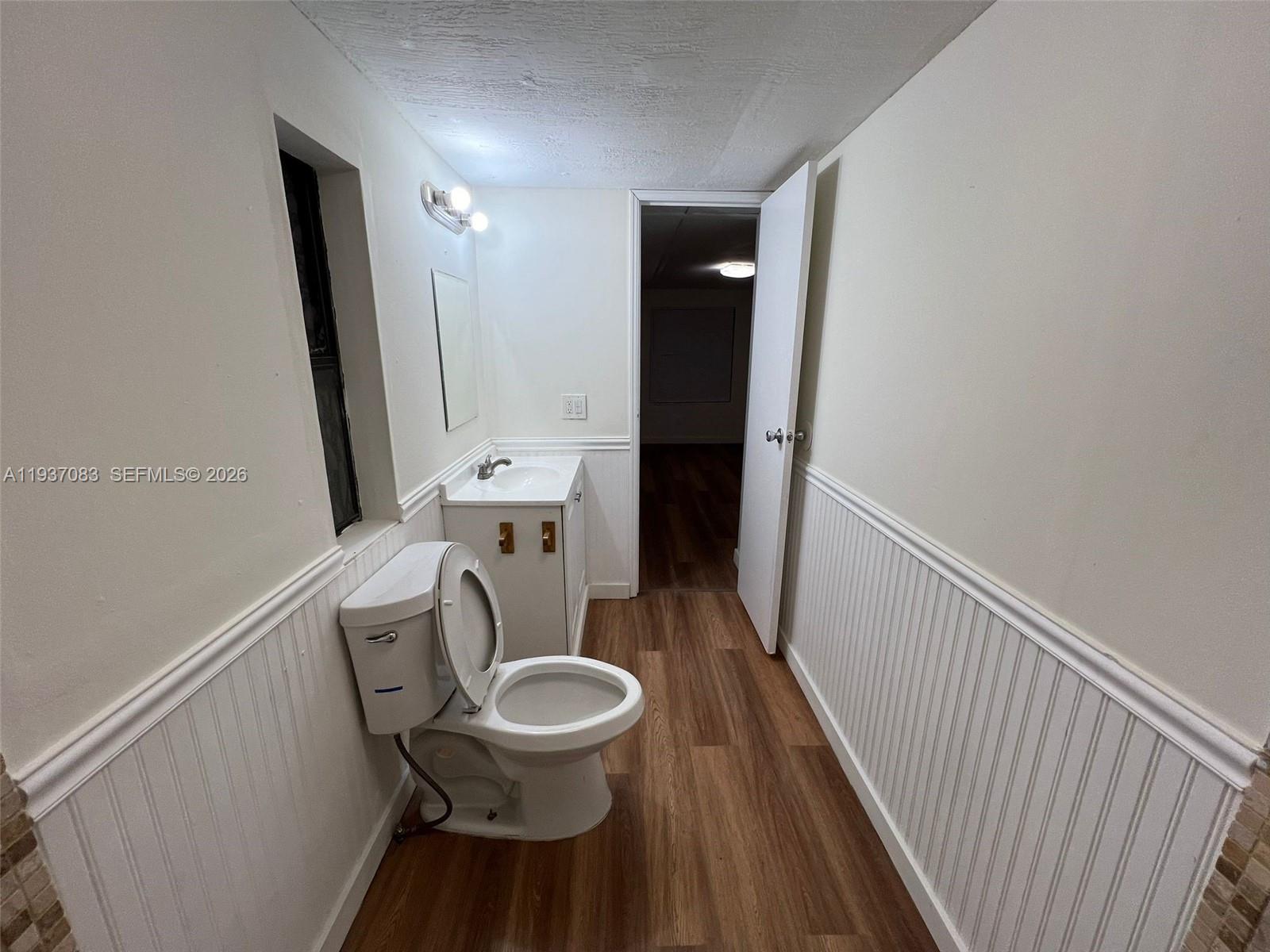 10492 South 228th Lane, Unit A Boca Raton, FL 33428 - Photo 6 of 37 a bathroom with a toilet a sink and a mirror