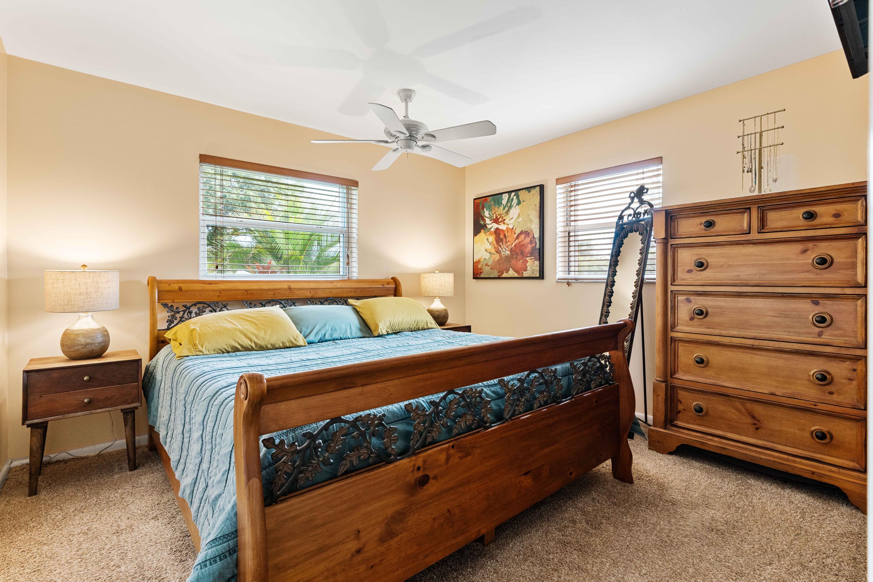 212 West Whitney Drive Jupiter, FL 33458 - Photo 12 of 23 a bed room with a bed and a dresser