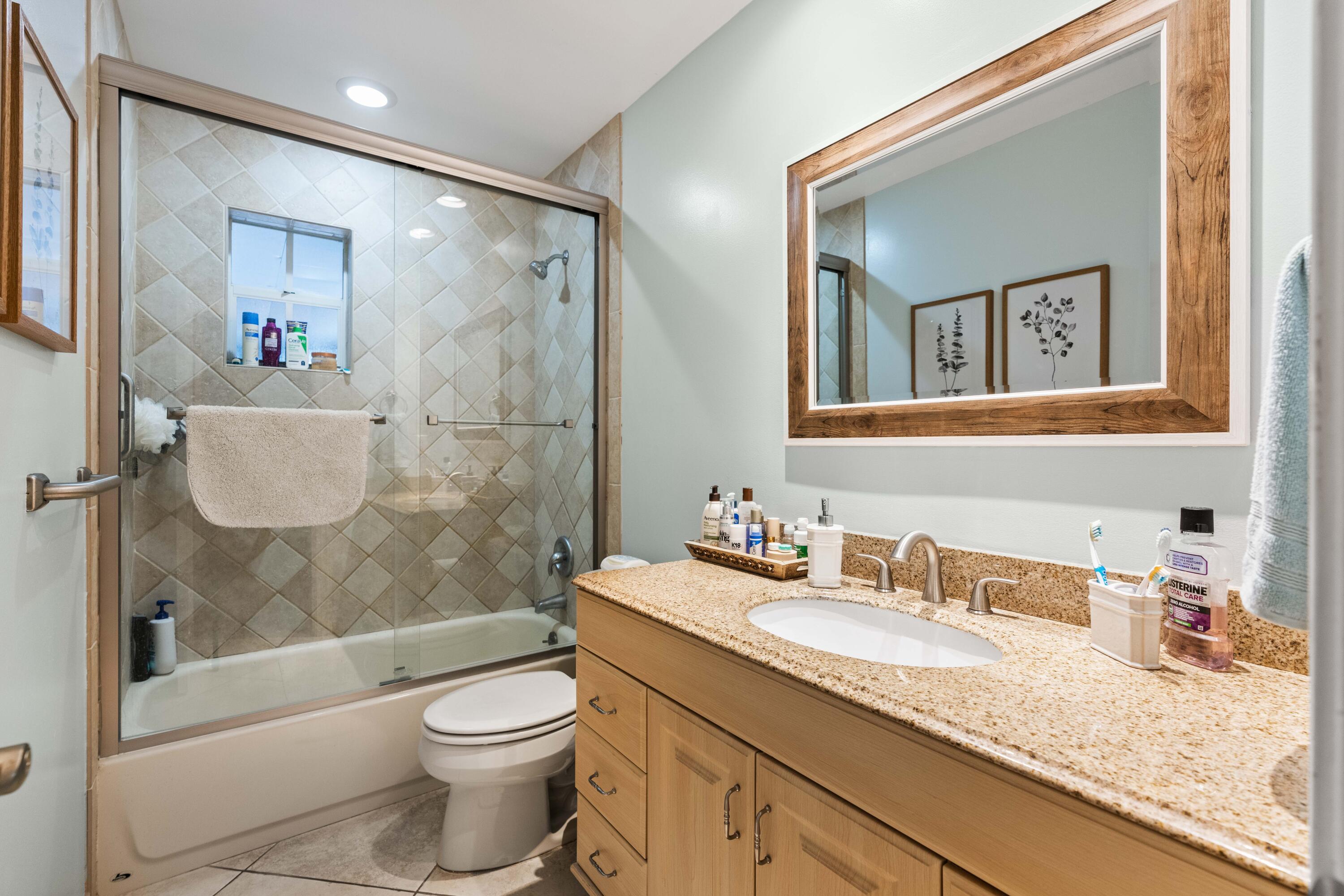 212 West Whitney Drive Jupiter, FL 33458 - Photo 14 of 23 a bathroom with a granite countertop sink toilet and shower