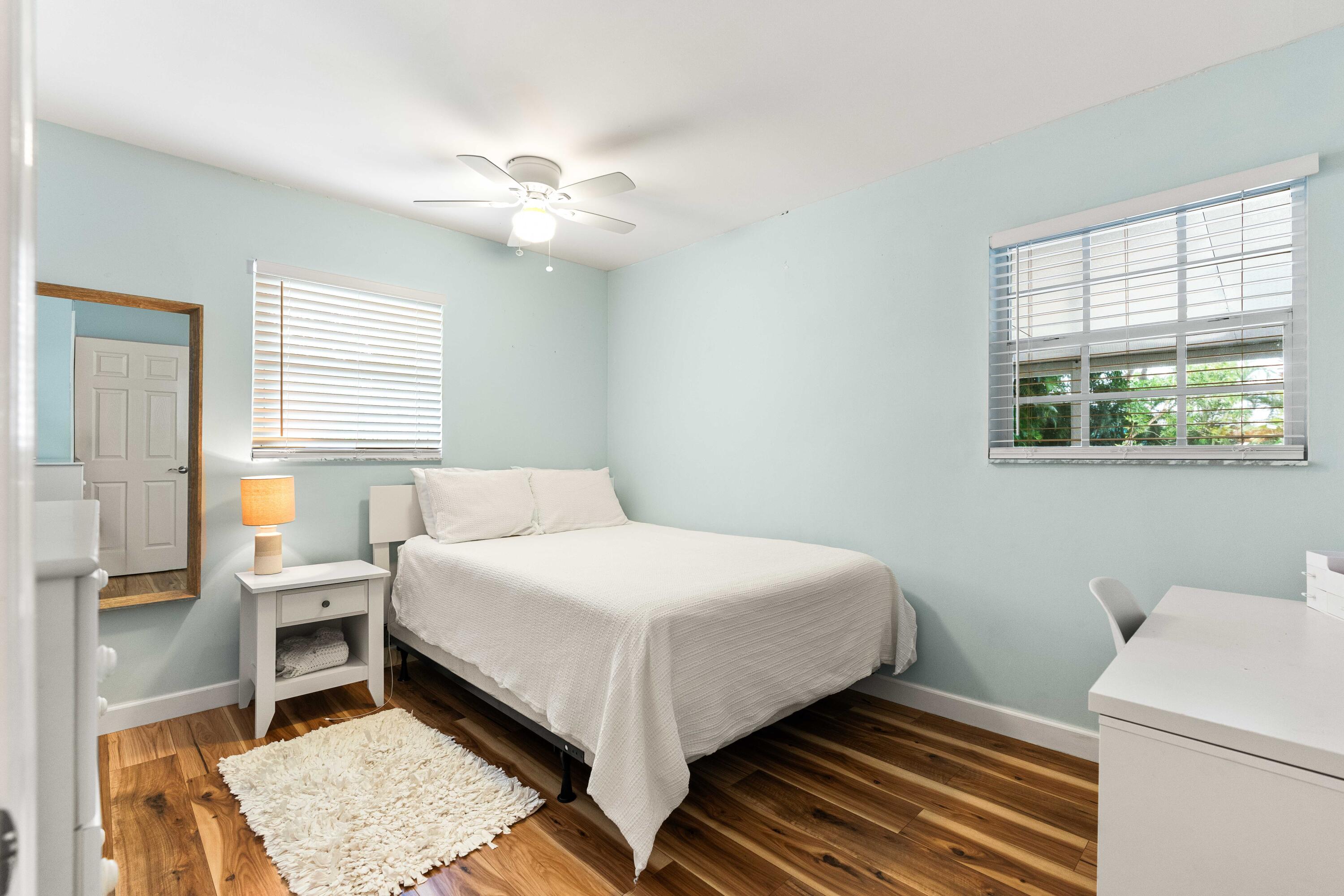 212 West Whitney Drive Jupiter, FL 33458 - Photo 15 of 23 a bedroom with a bed and a window