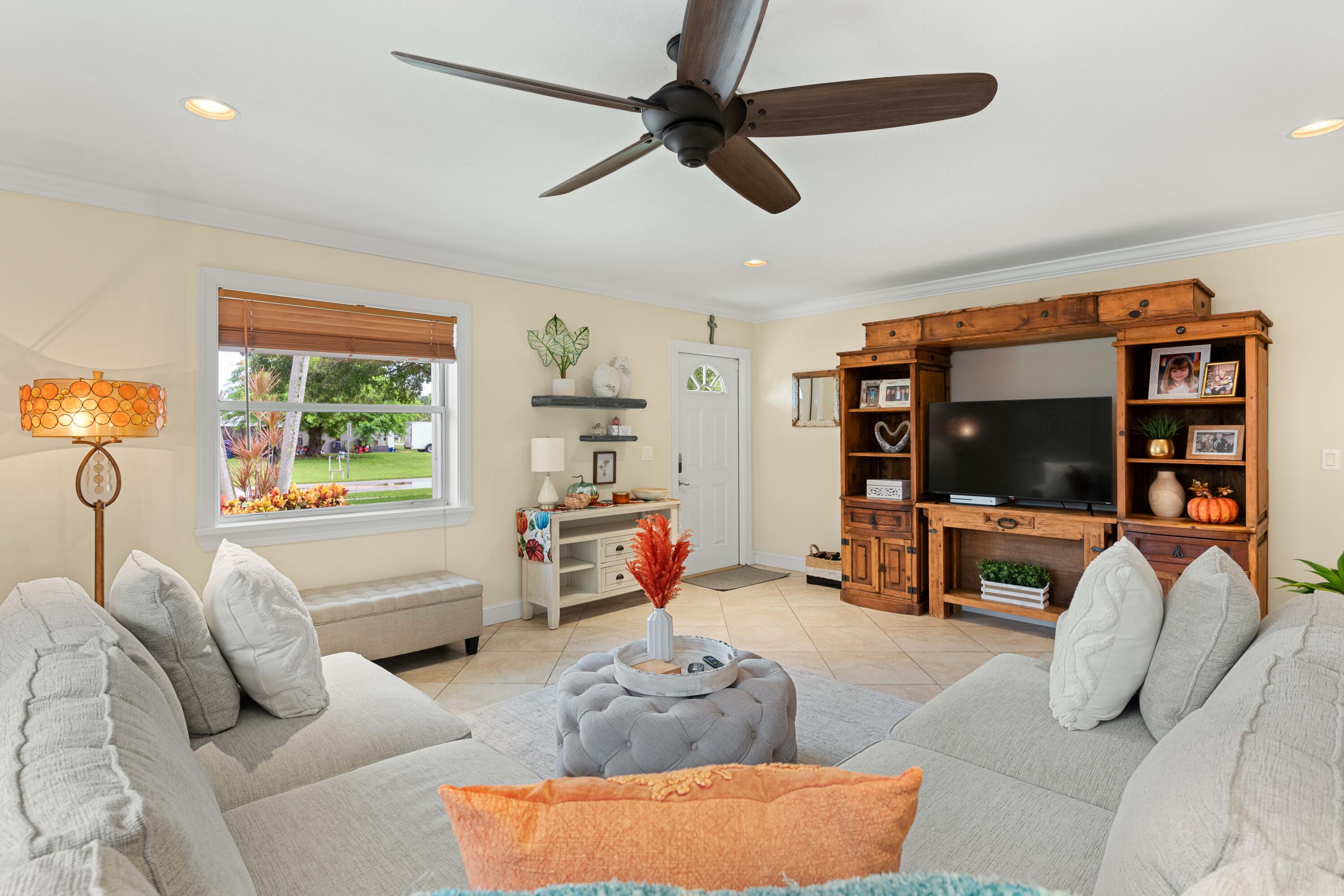 212 West Whitney Drive Jupiter, FL 33458 - Photo 19 of 23 a living room with furniture and a flat screen tv