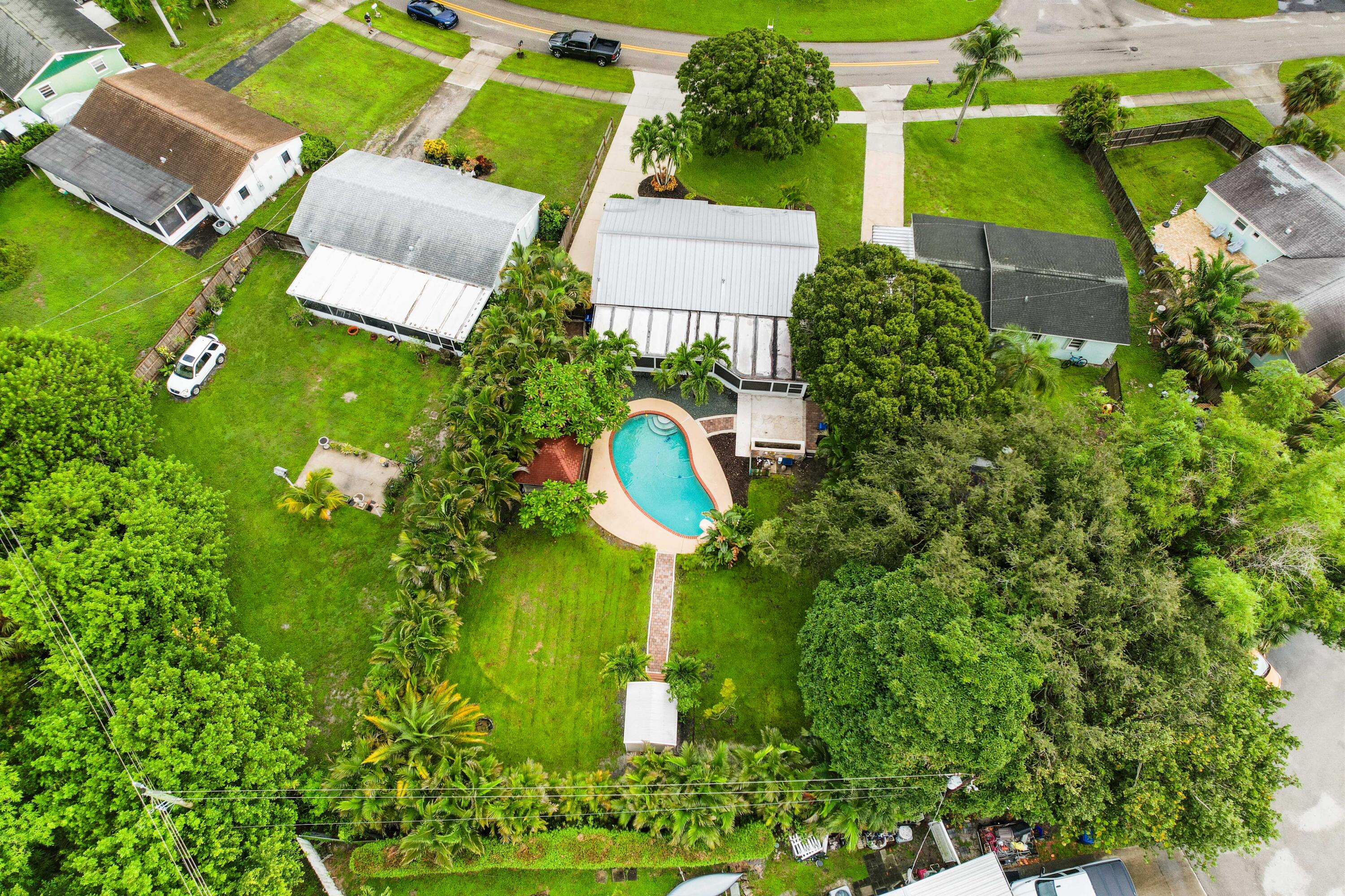 212 West Whitney Drive Jupiter, FL 33458 - Photo 20 of 23 an aerial view of a house with a garden and lots of green space