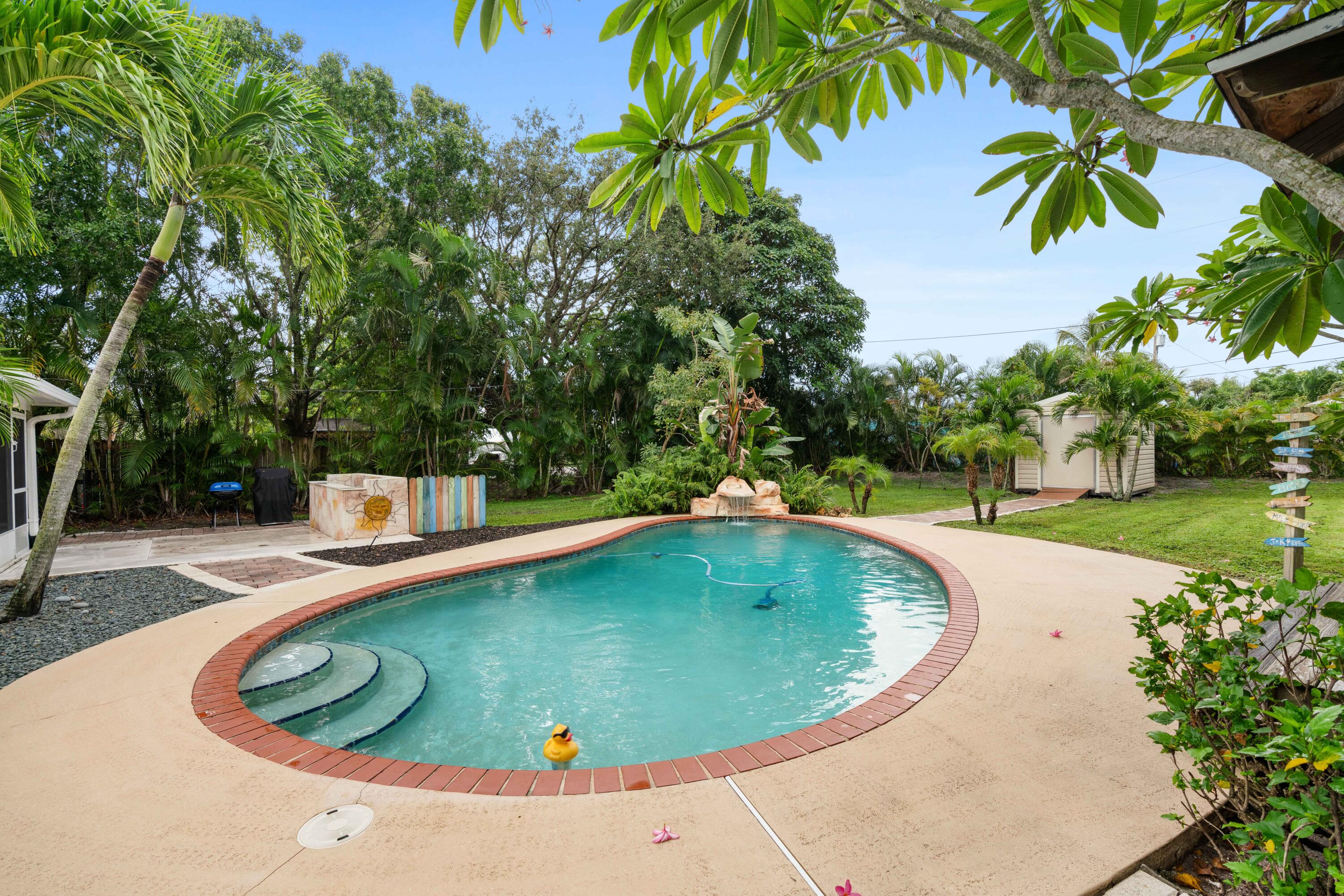 212 West Whitney Drive Jupiter, FL 33458 - Photo 2 of 23 a view of a swimming pool with a patio