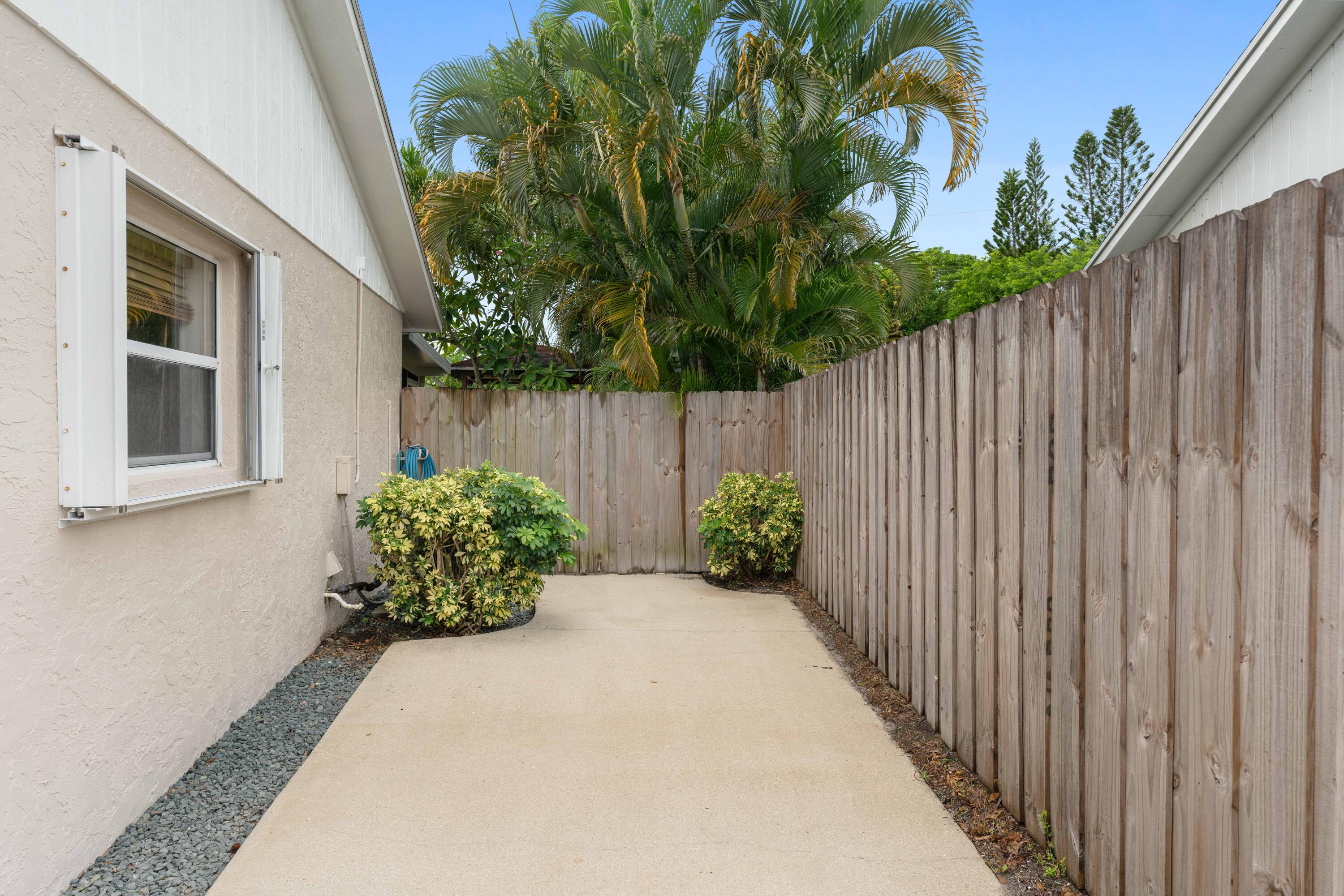 212 West Whitney Drive Jupiter, FL 33458 - Photo 22 of 23 a bunch of flowers with wooden fence