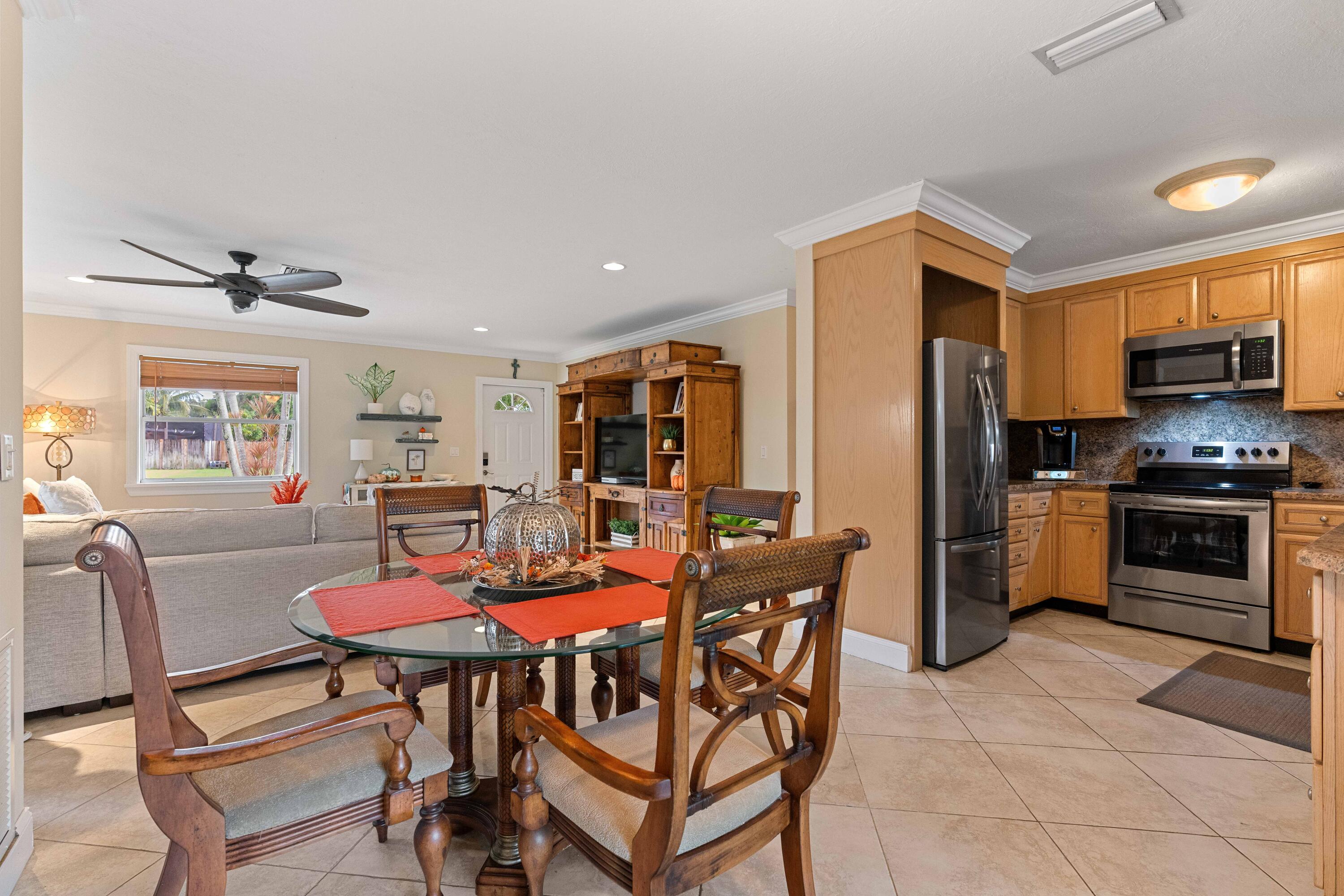 212 West Whitney Drive Jupiter, FL 33458 - Photo 3 of 23 a view of a dining room with furniture and a window