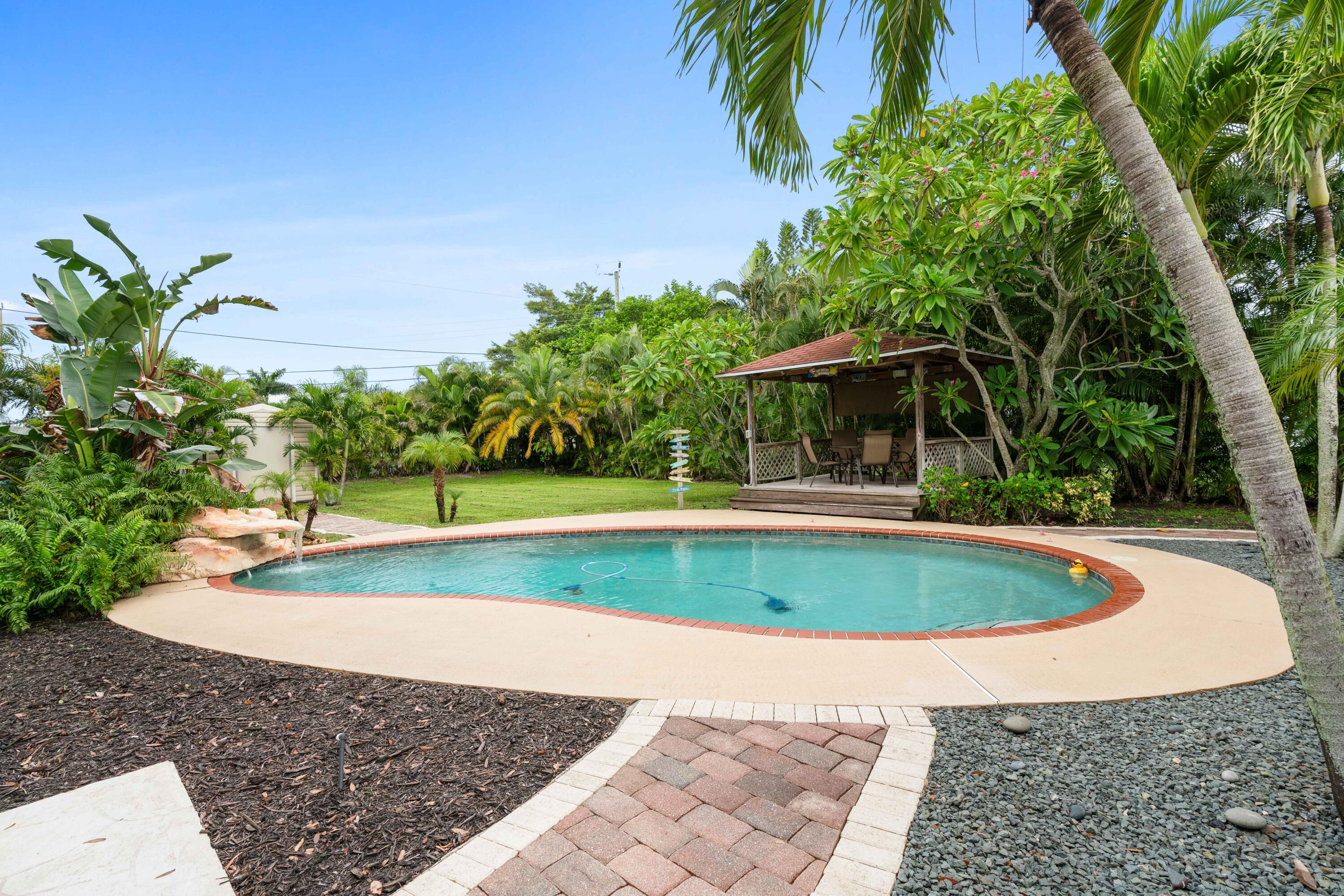 212 West Whitney Drive Jupiter, FL 33458 - Photo 7 of 23 a view of a swimming pool with a patio