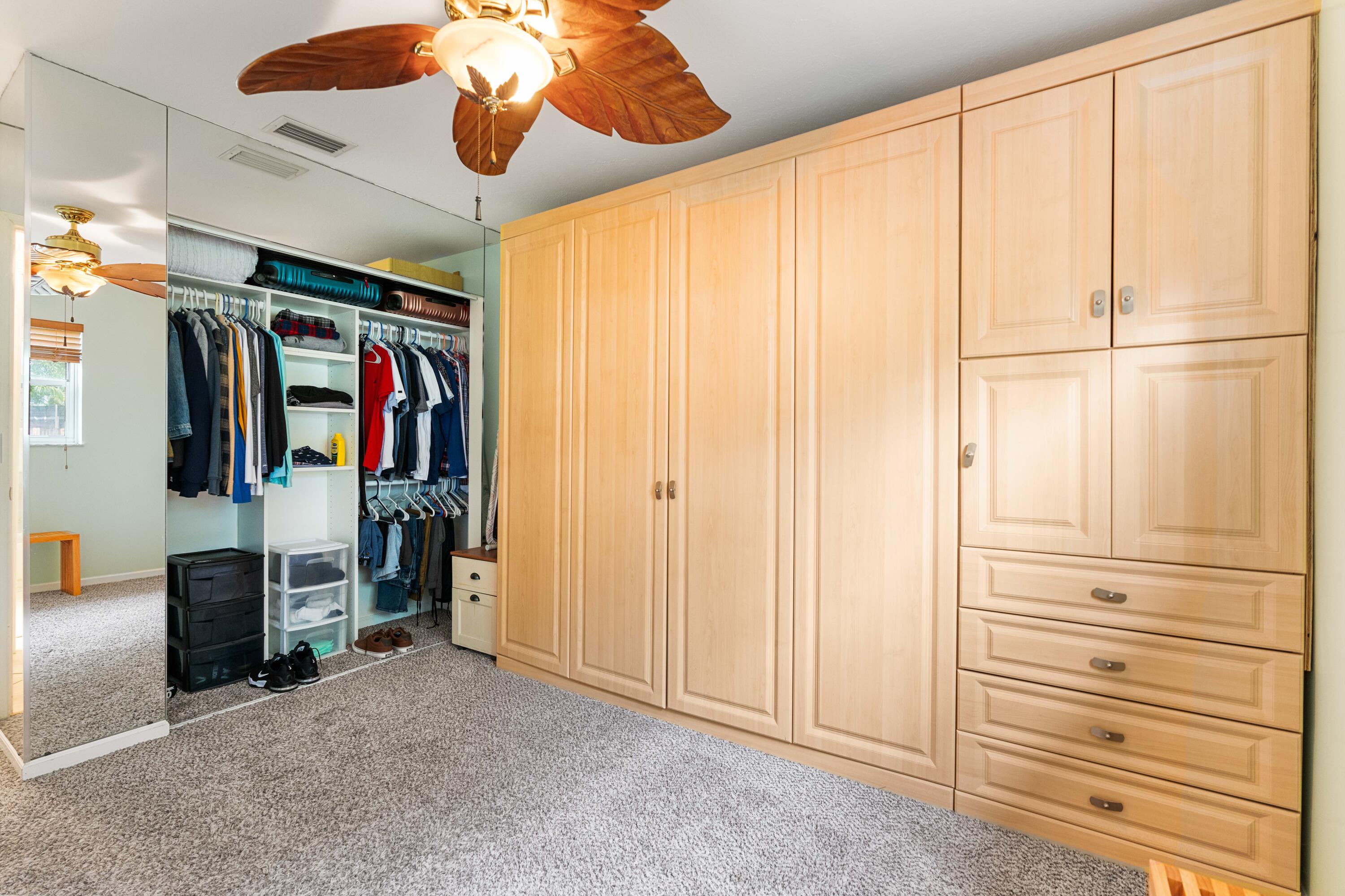 212 West Whitney Drive Jupiter, FL 33458 - Photo 10 of 23 a view of walk in closet with clothes
