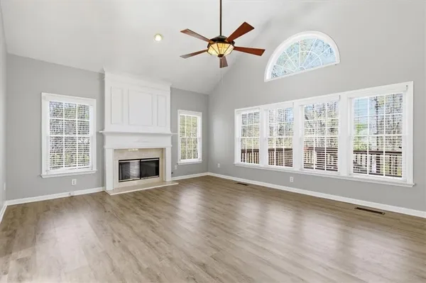 a view of a livingroom with wooden floor and a ceiling fan