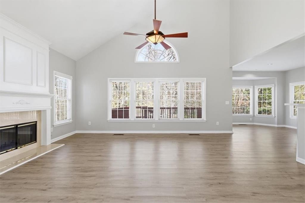 1660 Rosemist Trail Grayson, GA 30017 - Photo 12 of 52 a view of an empty room with wooden floor and a window