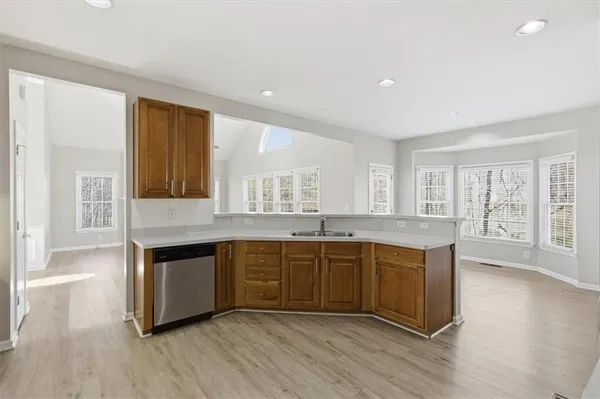 a kitchen with stainless steel appliances granite countertop a refrigerator stove and sink