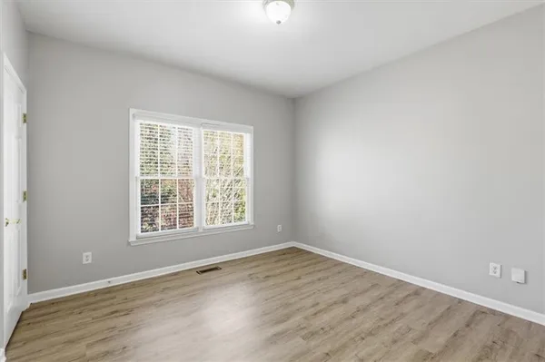 a view of an empty room and wooden floor