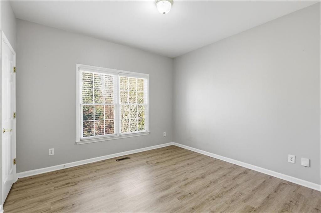 1660 Rosemist Trail Grayson, GA 30017 - Photo 21 of 52 an empty room with wooden floor and windows