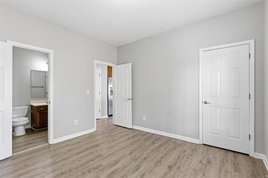 1660 Rosemist Trail Grayson, GA 30017 - Photo 22 of 52 a view of an empty room and wooden floor