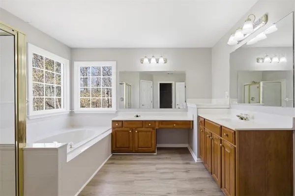 a bathroom with a bathtub shower and sink