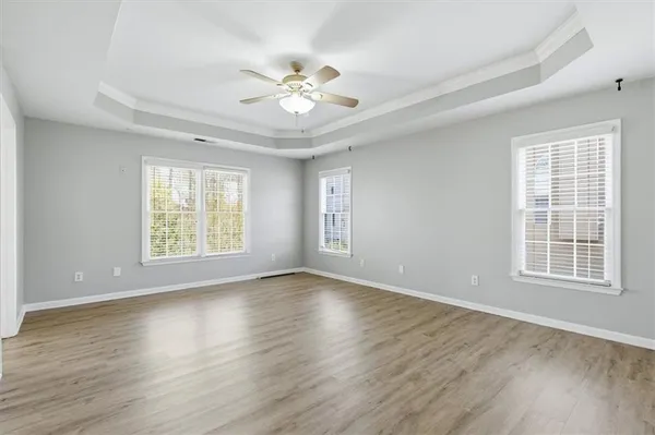 a view of an empty room with wooden floor