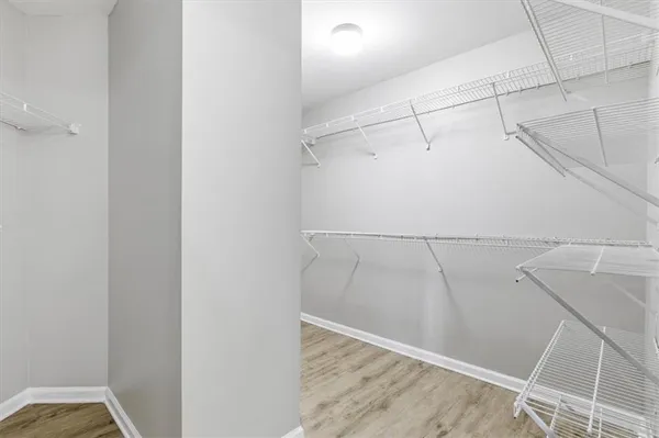a view of walk in closet with empty racks