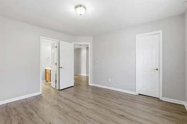 a spacious bathroom with a shower a sink and a mirror