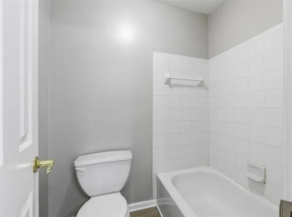 a bedroom with a bed and a potted plant