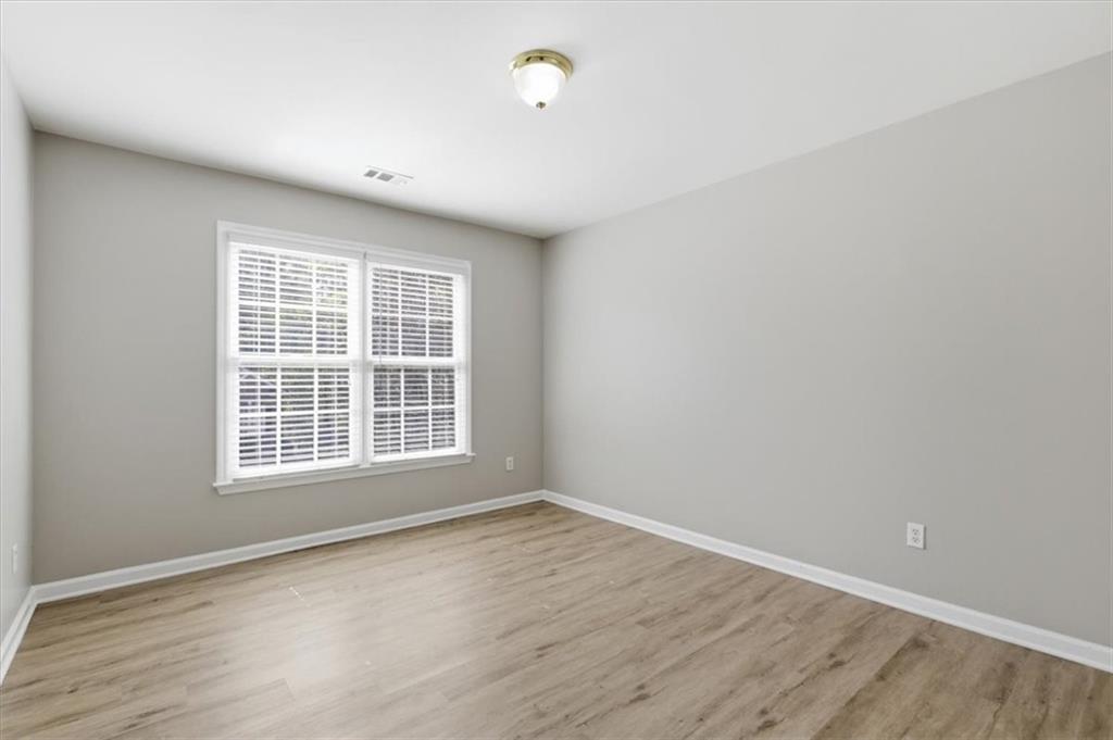 1660 Rosemist Trail Grayson, GA 30017 - Photo 33 of 52 an empty room with wooden floor and windows