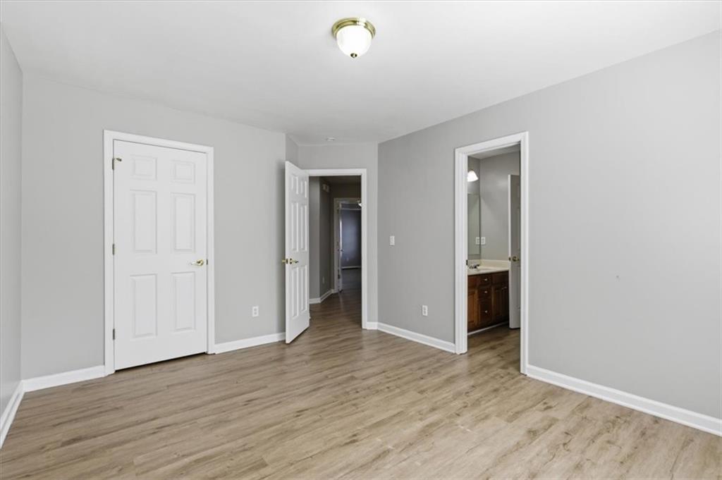 1660 Rosemist Trail Grayson, GA 30017 - Photo 34 of 52 a view of an empty room with wooden floor and closet