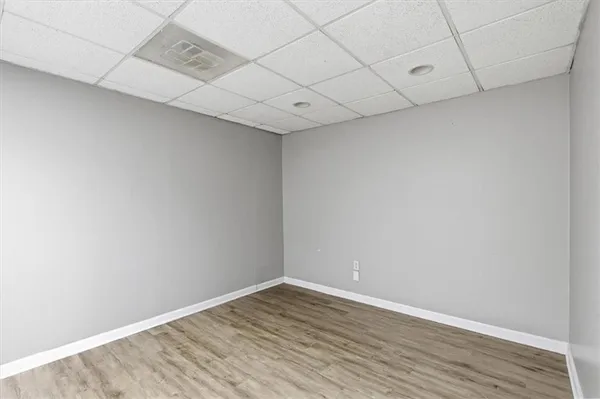 a bathroom with a granite countertop toilet sink and mirror