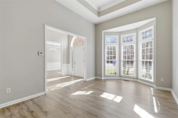 a view of an empty room with wooden floor and entryway