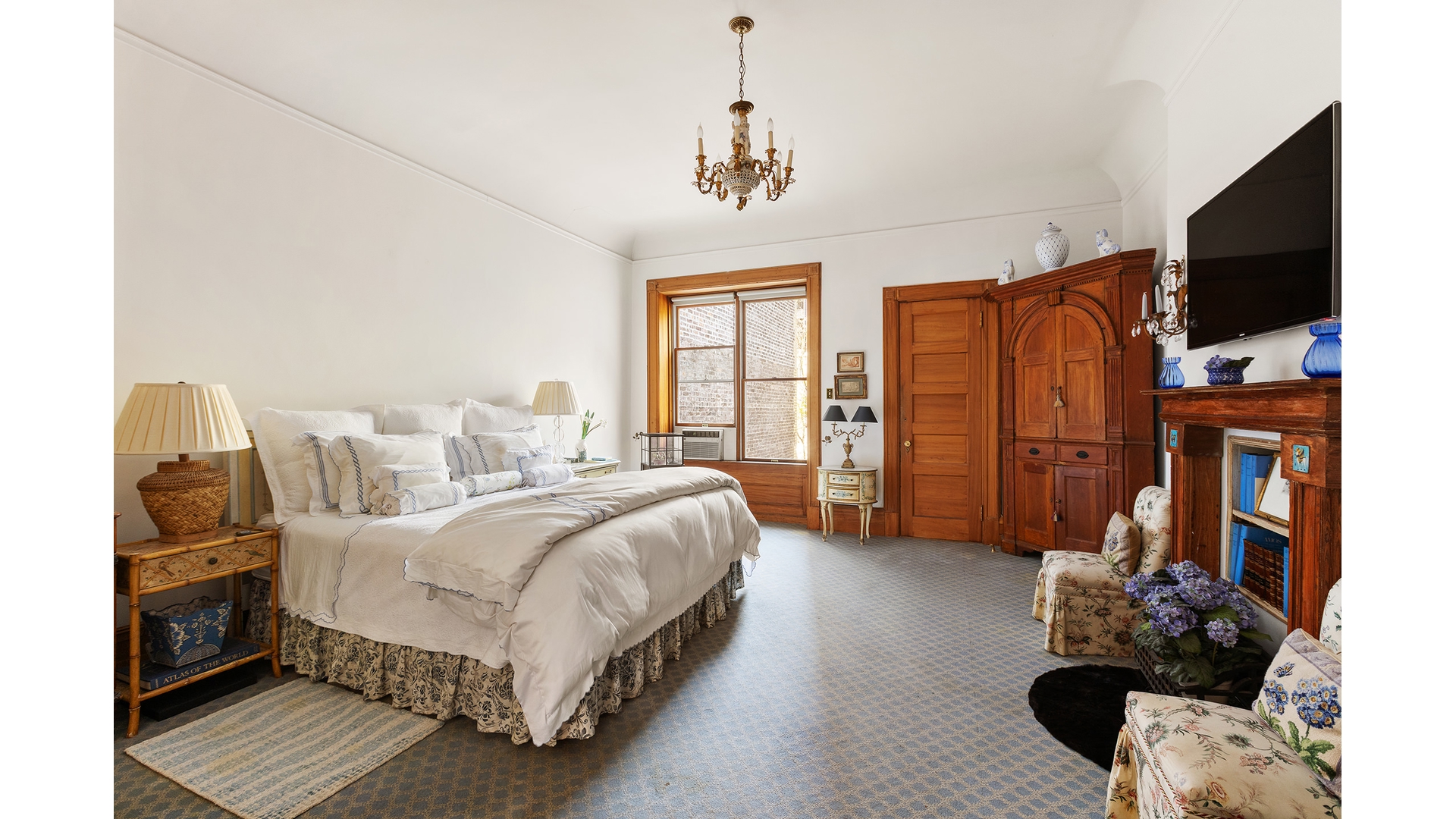 321 West 77th Street Manhattan, NY 10024 - Photo 11 of 12 a spacious bedroom with a bed window and flat screen tv