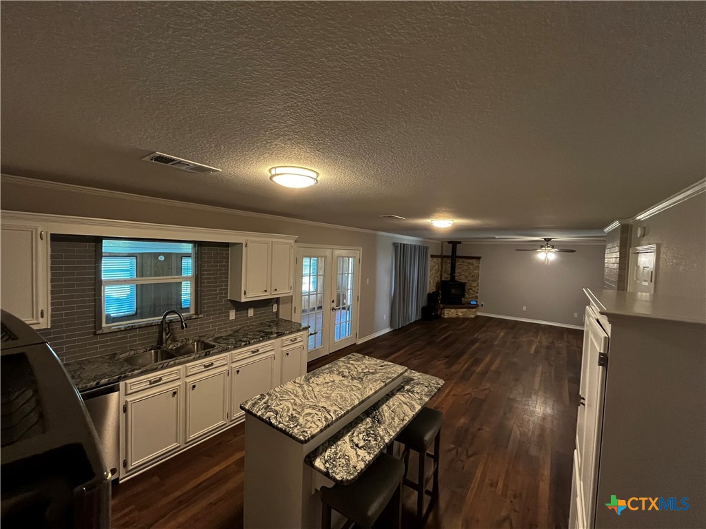 151 Mockingbird Lane Lampasas, TX 76550 - Photo 6 of 22 a large kitchen with a sink a counter space and stainless steel appliances