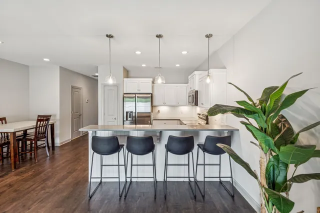 a view of a dining room with furniture wooden floor and chandelier