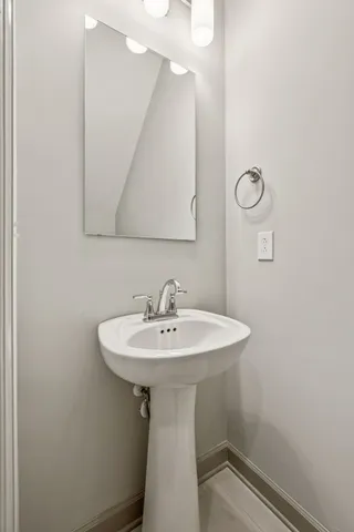 a bathroom with a sink a mirror and a toilet