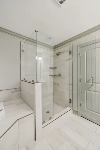 a bathroom with a shower and a sink a mirror