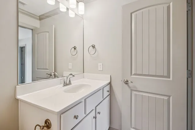 a bathroom with a sink vanity and a mirror