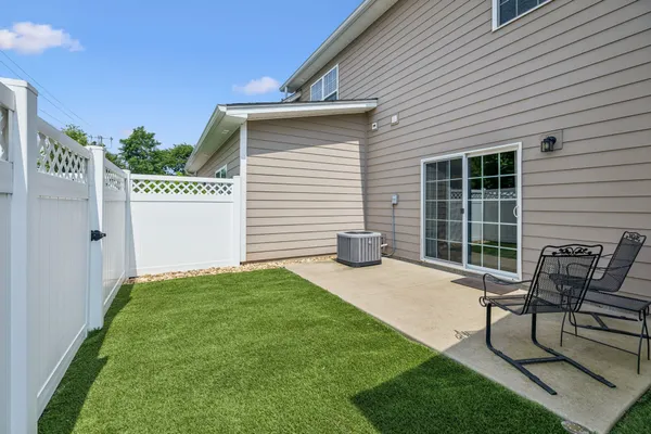 a view of a house with backyard and sitting area