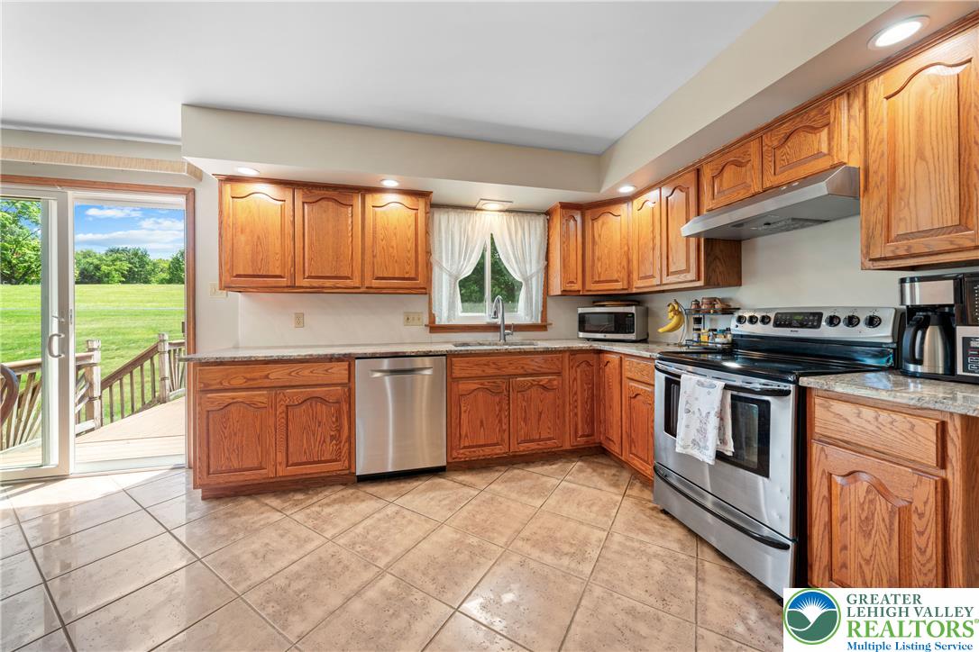 947 Tamenend Road Bath, PA 18014 - Photo 11 of 61 A well-equipped kitchen features a suite of stainless steel appliances, abundant cabinetry, and convenient outdoor access.