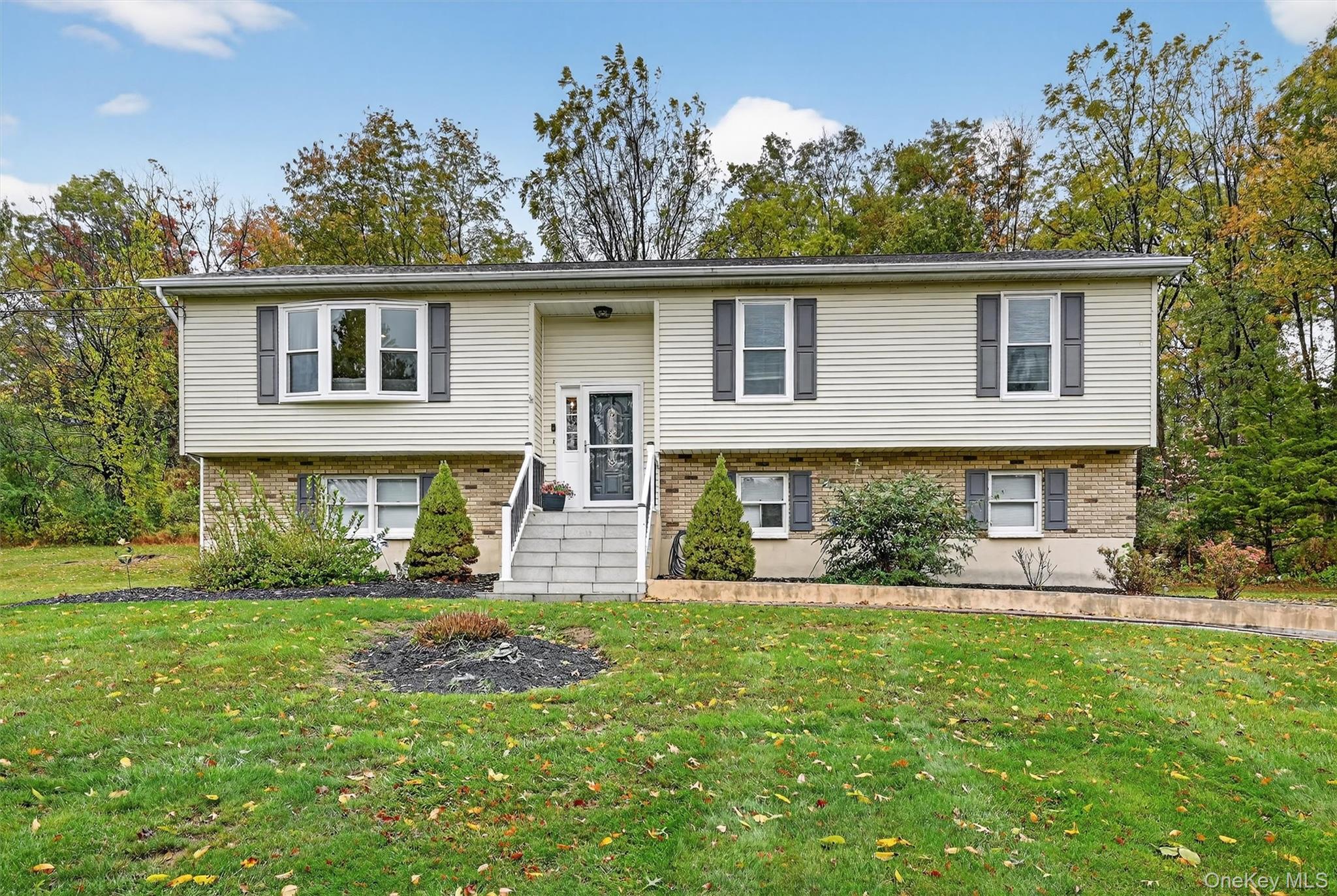 Bi-level home with a front yard