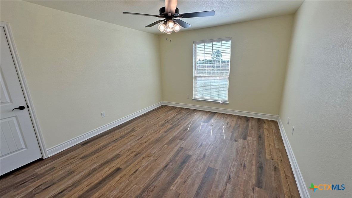 4237 Cool Basin Road Kempner, TX 76539 - Photo 19 of 36 wooden floor in an empty room with a window