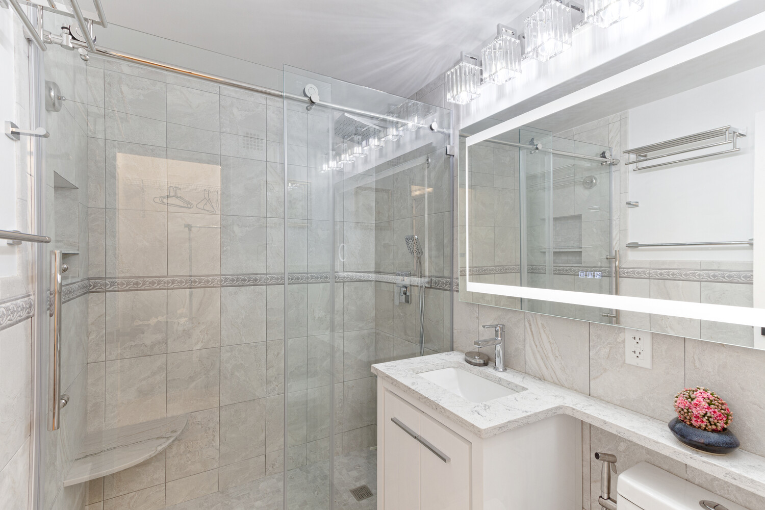 80 Park Avenue, Unit 6A Manhattan, NY 10016 - Photo 5 of 7 a bathroom with a sink vanity granite and shower