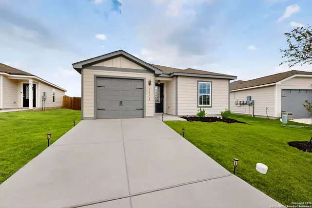 a front view of house with yard and green space