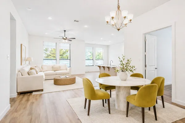 a view of a dining room with furniture and chandelier