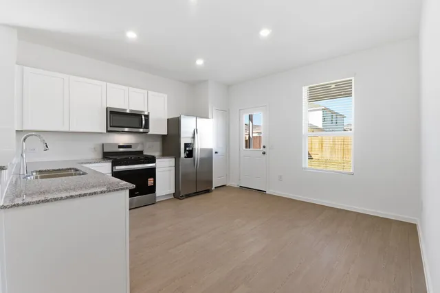 a kitchen with a refrigerator stove and microwave